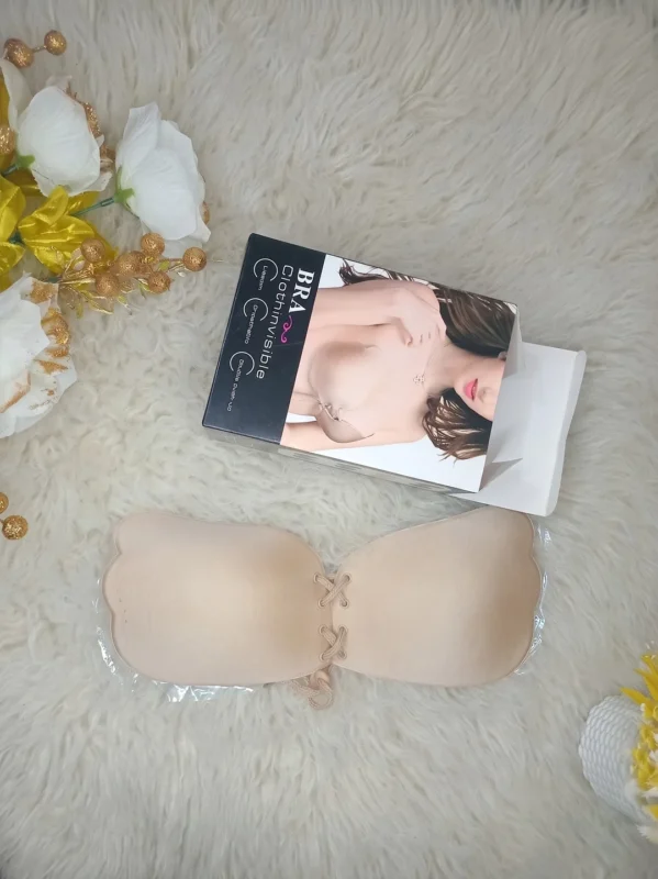 Flat lay of the Xelxia fabric outer invisible sticky bra with its packaging.