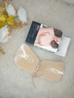 Flat lay of the Xelxia fabric outer invisible sticky bra with its packaging.
