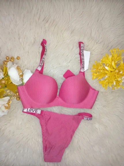 Flat lay of the Xelxia Raspberry pink bra and panty set showing ribbed fabric texture and crystal details.