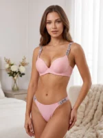 Model wearing the Xelxia Rose Pink ribbed lingerie set featuring sparkling rhinestone Love straps.